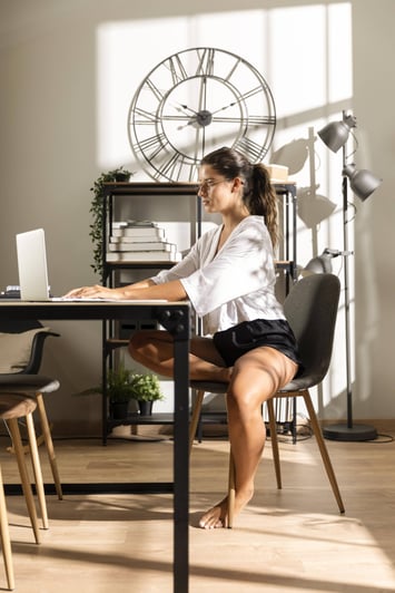 woman-sitting-table-working-laptop